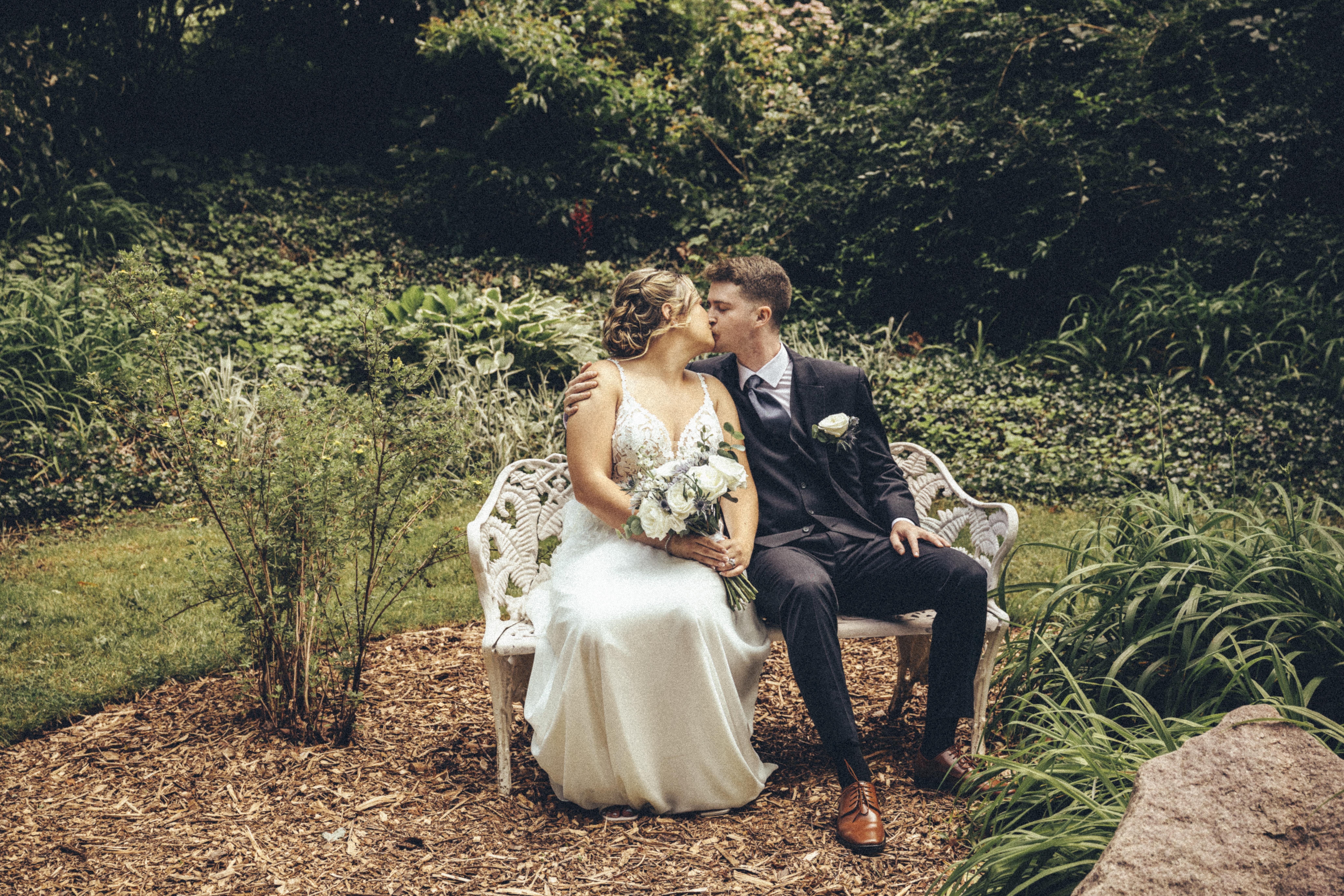 wedding photo on a bench in the garden